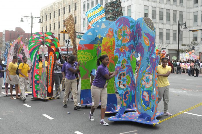 Animodules being pulled down the street in a parade